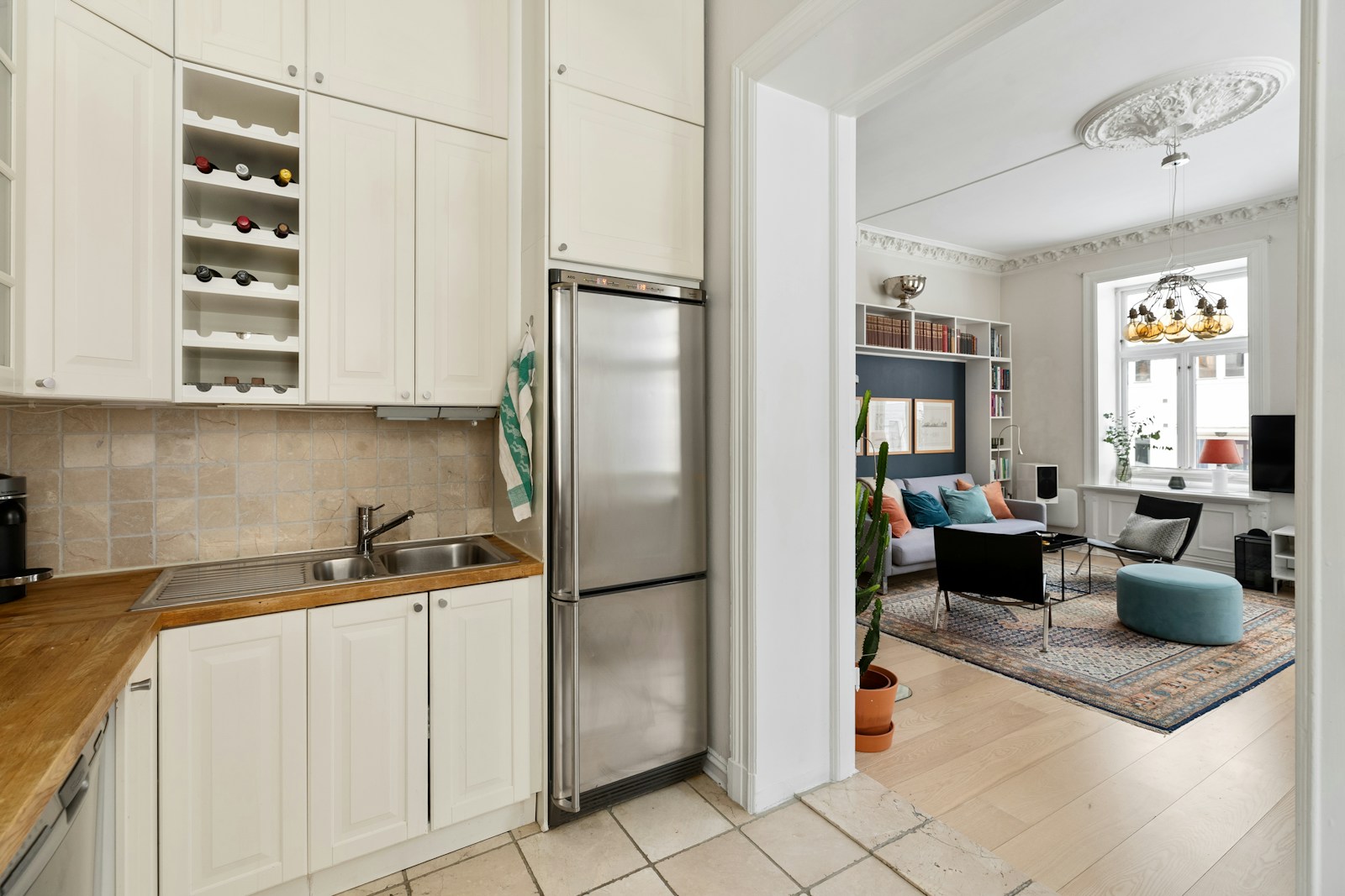 Bright residential kitchen with a stainless steel refrigerator and range